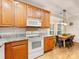 Bright kitchen with wood cabinets, granite countertops, leading to adjacent dining area at 705 Torrey Pines Ln, Fort Mill, SC 29715