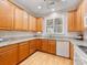 Traditional-style kitchen with wood cabinets, light countertops, and appliances at 705 Torrey Pines Ln, Fort Mill, SC 29715