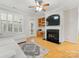 Spacious living room featuring a fireplace, built-in shelving, and hardwood floors at 705 Torrey Pines Ln, Fort Mill, SC 29715