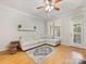 Cozy living room with hardwood floors, white couch, and neutral decor at 705 Torrey Pines Ln, Fort Mill, SC 29715