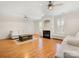 Bright living room with hardwood floors, lots of natural light, fireplace and modern ceiling fans at 705 Torrey Pines Ln, Fort Mill, SC 29715
