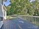 Relaxing back deck with painted wood and railing overlooking lush green backyard at 7309 Rock Hampton Ct, Harrisburg, NC 28075