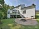 Large backyard featuring a patio with a fire pit and grill, connected to the home's deck and upper level at 7309 Rock Hampton Ct, Harrisburg, NC 28075