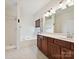 Bathroom featuring double vanity, soaking tub, and separate shower at 7309 Rock Hampton Ct, Harrisburg, NC 28075