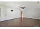 Large bedroom featuring hardwood floors, ceiling fan, and ample closet space at 7309 Rock Hampton Ct, Harrisburg, NC 28075