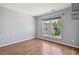 Bedroom with large window for natural light and hardwood floors, providing a serene and inviting atmosphere at 7309 Rock Hampton Ct, Harrisburg, NC 28075