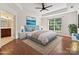 Staged bedroom with trey ceilings, hardwood floors, and ensuite bathroom at 7309 Rock Hampton Ct, Harrisburg, NC 28075