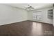Spacious bedroom with ceiling fan, hardwood floors, built in shelves and natural light creating an inviting space at 7309 Rock Hampton Ct, Harrisburg, NC 28075