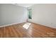 Bright bedroom with hardwood floors and a large window, offering a simple and comfortable living space at 7309 Rock Hampton Ct, Harrisburg, NC 28075