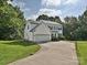 Charming two-story home with a driveway, well-manicured lawn, and a basketball hoop at 7309 Rock Hampton Ct, Harrisburg, NC 28075