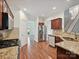 Spacious kitchen with stainless steel appliances, granite countertops, and hardwood floors at 7309 Rock Hampton Ct, Harrisburg, NC 28075