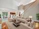 Staged living room featuring hardwood floors, neutral furniture, and natural light at 7309 Rock Hampton Ct, Harrisburg, NC 28075
