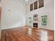 Bright living room boasts hardwood floors, a fireplace, and tall windows with custom blinds at 7309 Rock Hampton Ct, Harrisburg, NC 28075