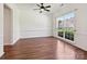 Bright dining room featuring hardwood floors, a ceiling fan, and a large window at 7309 Rock Hampton Ct, Harrisburg, NC 28075