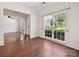 Bright living room featuring hardwood floors, a large window, and an open layout at 7309 Rock Hampton Ct, Harrisburg, NC 28075