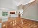Open-concept living room with hardwood floors and view of staircase and kitchen at 7309 Rock Hampton Ct, Harrisburg, NC 28075