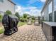 Paver patio with lawn chairs, grill, and lush lawn in a fenced backyard at 741 Garrett Green Way # 64, Fort Mill, SC 29715
