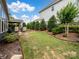 Manicured backyard with a paver patio, a grill, and garden beds at 741 Garrett Green Way # 64, Fort Mill, SC 29715