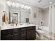 Well-lit bathroom with double sink, shower-tub combo, and large mirror at 741 Garrett Green Way # 64, Fort Mill, SC 29715