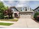 Charming home featuring a two-car garage and a manicured lawn with mature tree and American flag at 741 Garrett Green Way # 64, Fort Mill, SC 29715