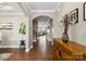 Open hallway with hardwood floors, elegant archway, and staircase leading to the upper level at 741 Garrett Green Way # 64, Fort Mill, SC 29715