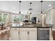 Open concept, showcasing kitchen and island flowing to the living room with fireplace feature at 741 Garrett Green Way # 64, Fort Mill, SC 29715