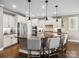 Well-lit kitchen island with stone countertops and bar stool seating, stainless steel appliances at 741 Garrett Green Way # 64, Fort Mill, SC 29715