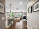 Open-concept living room with hardwood floors, fireplace, and seamless flow to the kitchen at 741 Garrett Green Way # 64, Fort Mill, SC 29715