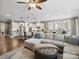 Open-concept living space with a large sofa, island seating, and a view into the modern kitchen at 741 Garrett Green Way # 64, Fort Mill, SC 29715
