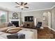 Cozy living room with a fireplace, large TV, ceiling fan, and comfortable seating arrangement at 741 Garrett Green Way # 64, Fort Mill, SC 29715