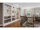 This loft area has custom built-in shelving, hardwood floors, and natural light at 741 Garrett Green Way # 64, Fort Mill, SC 29715