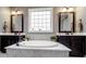 This is the soaking tub inside the main bathroom, with dual sinks on either side at 741 Garrett Green Way # 64, Fort Mill, SC 29715