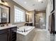 This main bathroom offers dual sinks, soaking tub, and a large glass shower with built in bench at 741 Garrett Green Way # 64, Fort Mill, SC 29715