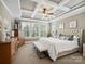 This main bedroom has tray ceilings, neutral paint and carpet, and lots of natural light at 741 Garrett Green Way # 64, Fort Mill, SC 29715
