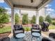 Relaxing covered patio area with comfortable seating and manicured landscaping at 741 Garrett Green Way # 64, Fort Mill, SC 29715