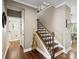 Elegant staircase with hardwood treads, iron railings, and neutral walls at 741 Garrett Green Way # 64, Fort Mill, SC 29715