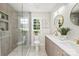 Modern bathroom with double sinks, walk-in shower and a large framed mirror at 811 Ashmeade Rd, Charlotte, NC 28211