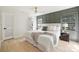 A well-lit bedroom with a panel wall, neutral tones, and hardwood floors at 811 Ashmeade Rd, Charlotte, NC 28211