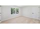 A bright, airy bedroom with hardwood floors and a large window at 811 Ashmeade Rd, Charlotte, NC 28211
