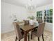 Chic dining room boasts clean lines, neutral furniture, elegant lighting, and a serene view from the large window at 811 Ashmeade Rd, Charlotte, NC 28211