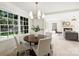 An open dining area with a round table and view into the living room at 811 Ashmeade Rd, Charlotte, NC 28211