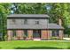 Charming two-story home with a brick and gray wood exterior, well-manicured lawn, and a welcoming front entrance at 811 Ashmeade Rd, Charlotte, NC 28211