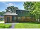 Charming two-story home features a brick and wood facade, complemented by lush greenery and a well-manicured lawn at 811 Ashmeade Rd, Charlotte, NC 28211