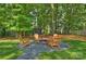 Cozy backyard fire pit area with Adirondack chairs on a gravel base at 811 Ashmeade Rd, Charlotte, NC 28211