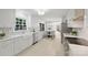 Bright kitchen with white cabinets, stainless steel appliances, and an adjacent dining area at 811 Ashmeade Rd, Charlotte, NC 28211