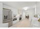 Modern kitchen features white cabinets, stainless steel appliances, tile backsplash, and open access to the dining area at 811 Ashmeade Rd, Charlotte, NC 28211