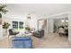 Open concept living room with large windows providing natural light and views of the backyard and access to stairs at 811 Ashmeade Rd, Charlotte, NC 28211