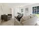 Sunlit living room features hardwood floors, neutral furniture, and ample natural light, highlighting its cozy and modern design at 811 Ashmeade Rd, Charlotte, NC 28211