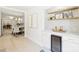 Stylish wet bar features open shelving, beverage cooler, marble countertop, and views into dining and kitchen areas at 811 Ashmeade Rd, Charlotte, NC 28211