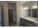Primary bathroom featuring double sink vanity, tile flooring, and glass shower at 8231 Annsborough Nw Dr, Concord, NC 28027